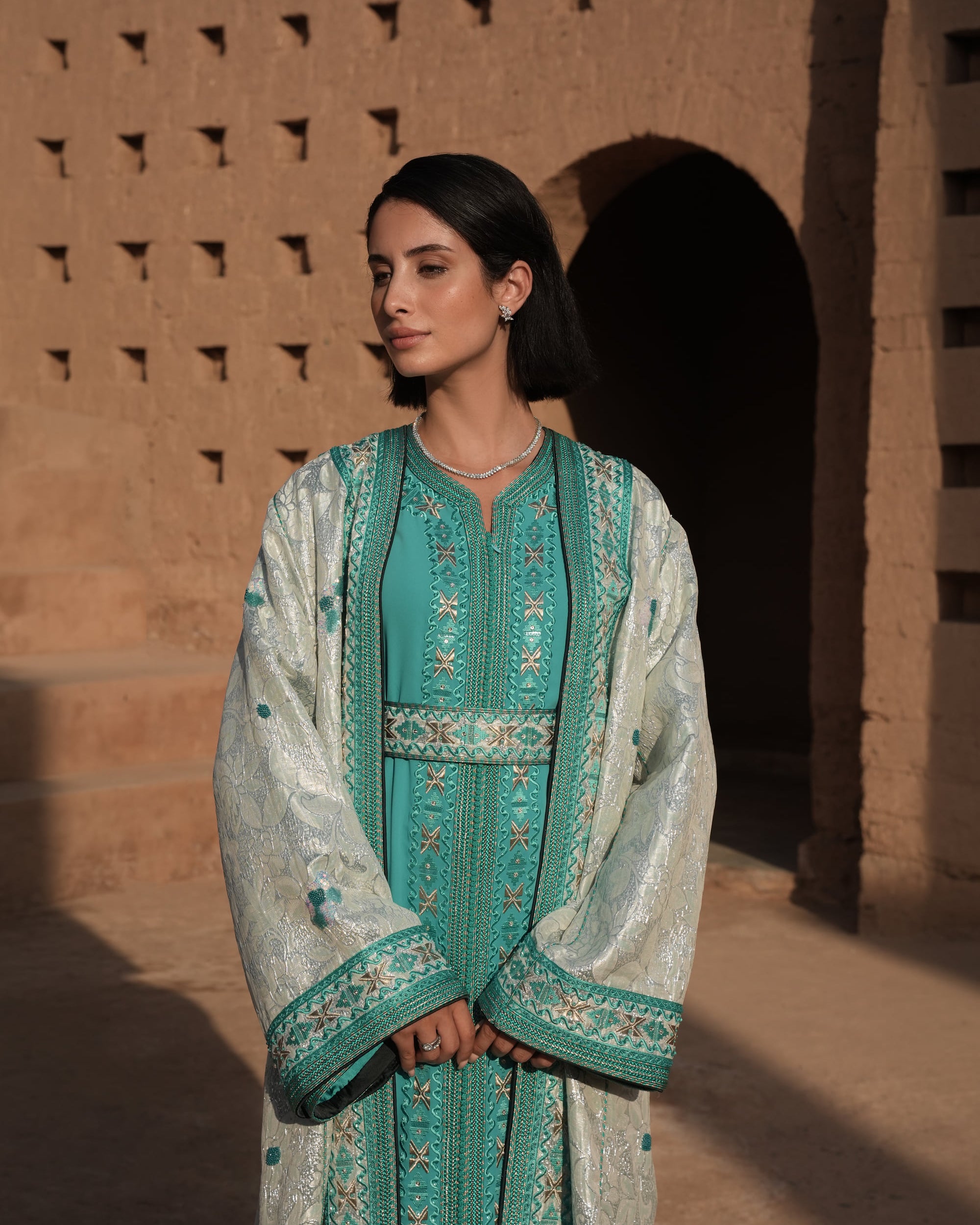 Azure Constellation turquoise Moroccan kaftan with star embroidery under an ivory brocade mansouria, full-length view