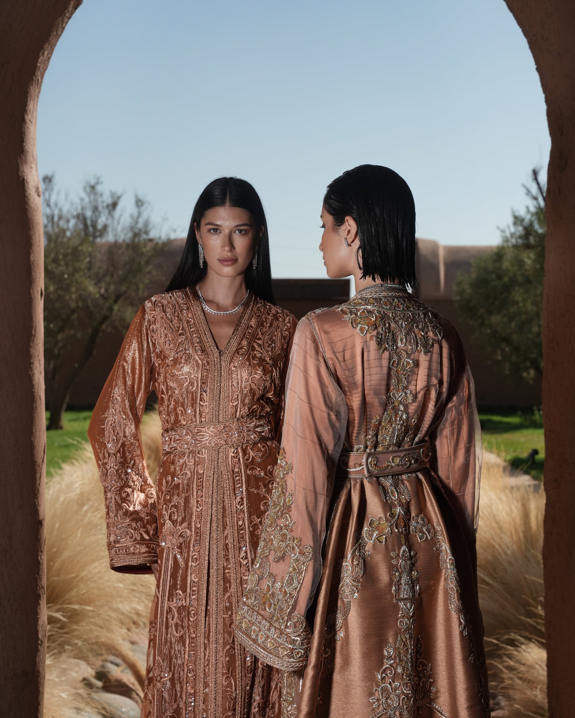 Copper Solstice devoré copper velvet Moroccan kaftan with tone-on-tone embroidery, shown alongside a second look