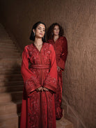 Garnet Adagio burgundy velvet Moroccan kaftan with tone-on-tone embroidery, matching belt and wide sleeves, shown alongside a second look