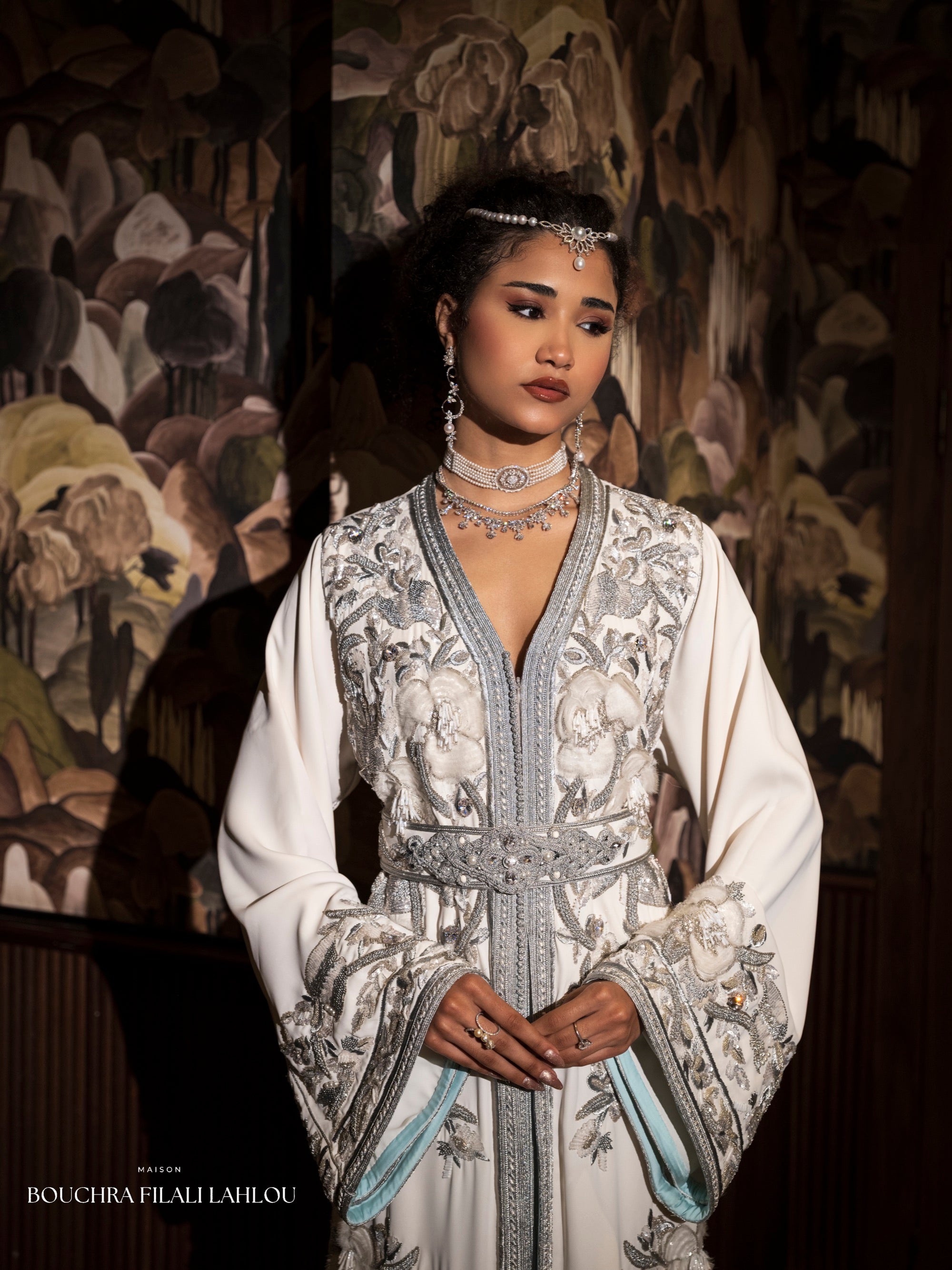 Ivory Moroccan caftan detail with silver embroidery, belted waist and pale blue lining